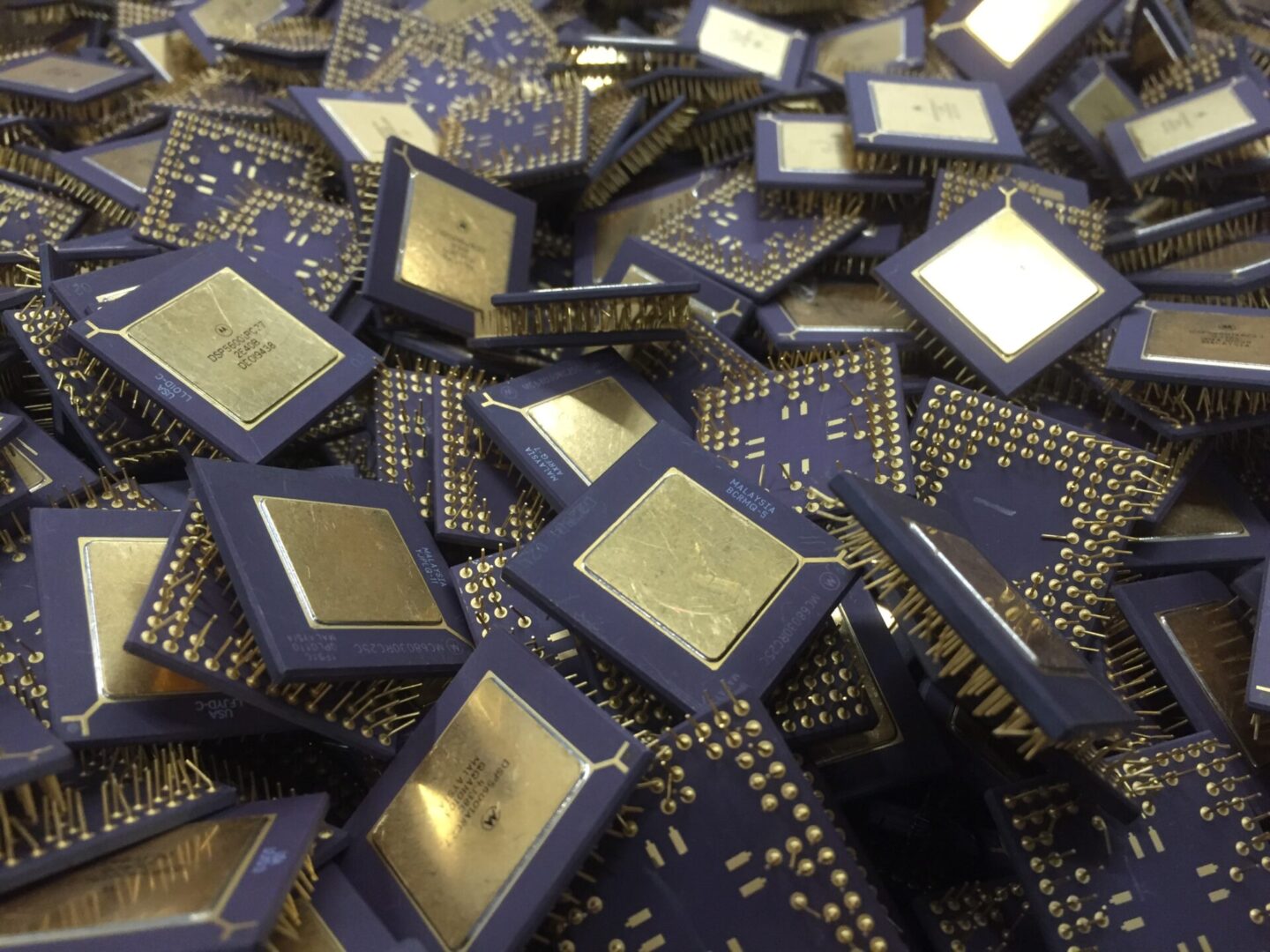 A pile of computer chips with gold on them.