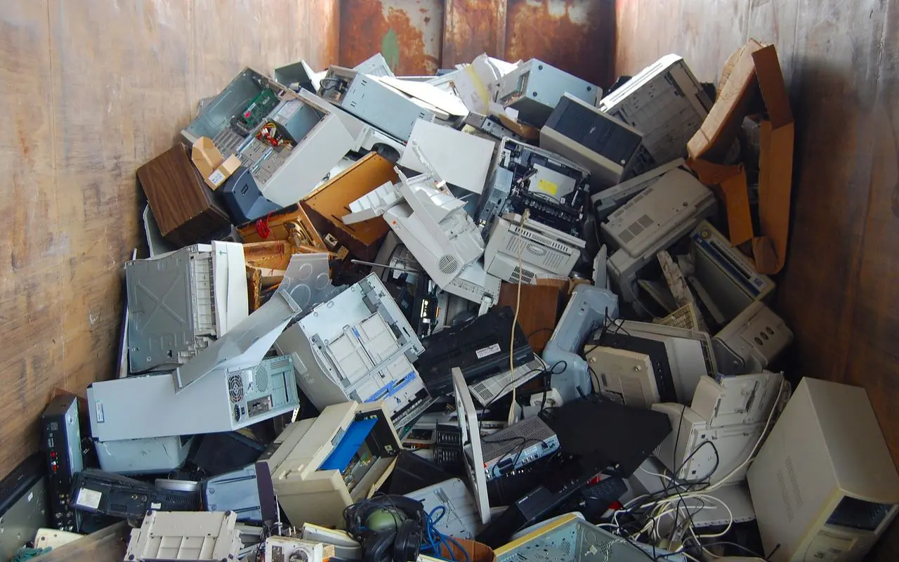 A pile of computer equipment sitting in the middle of a room.